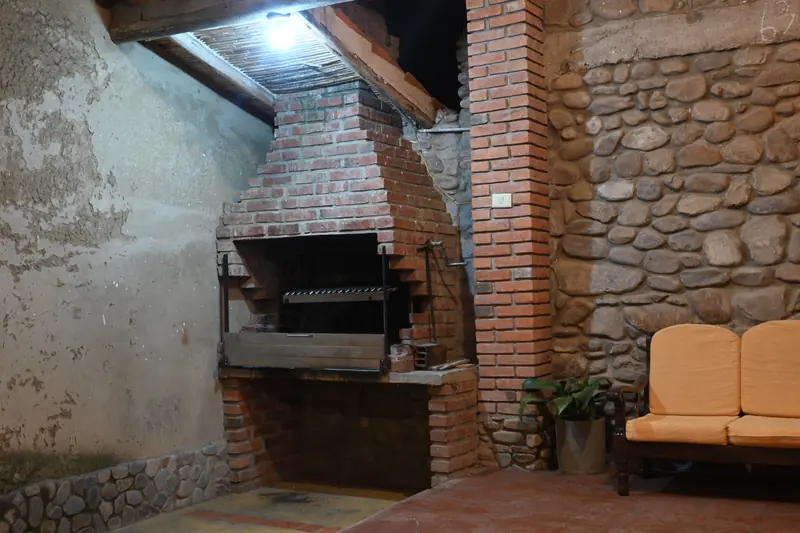 Parrilla junto a un muro de piedra en la Cabaña 2