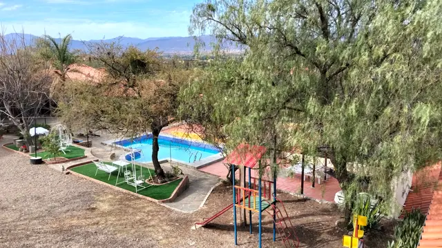 Vista de la piscina y los jardines de El Cadillar con los cerros de Tarija al fondo